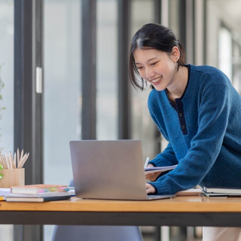 business-asian-woman-using-laptop-computer-and-working-at-office-with-calculator-document-on-desk-.jpg